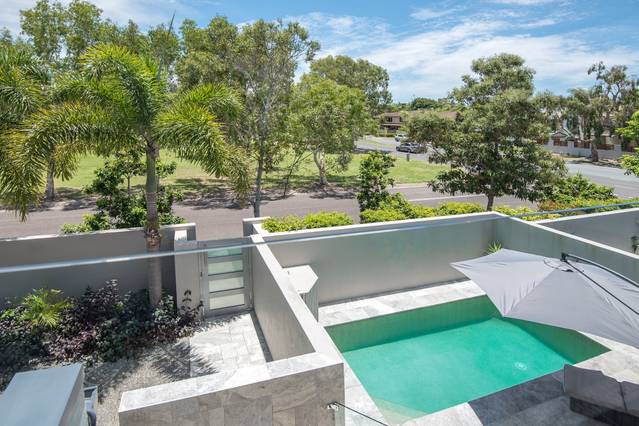 A deluxe holiday home with a beautiful pool and views